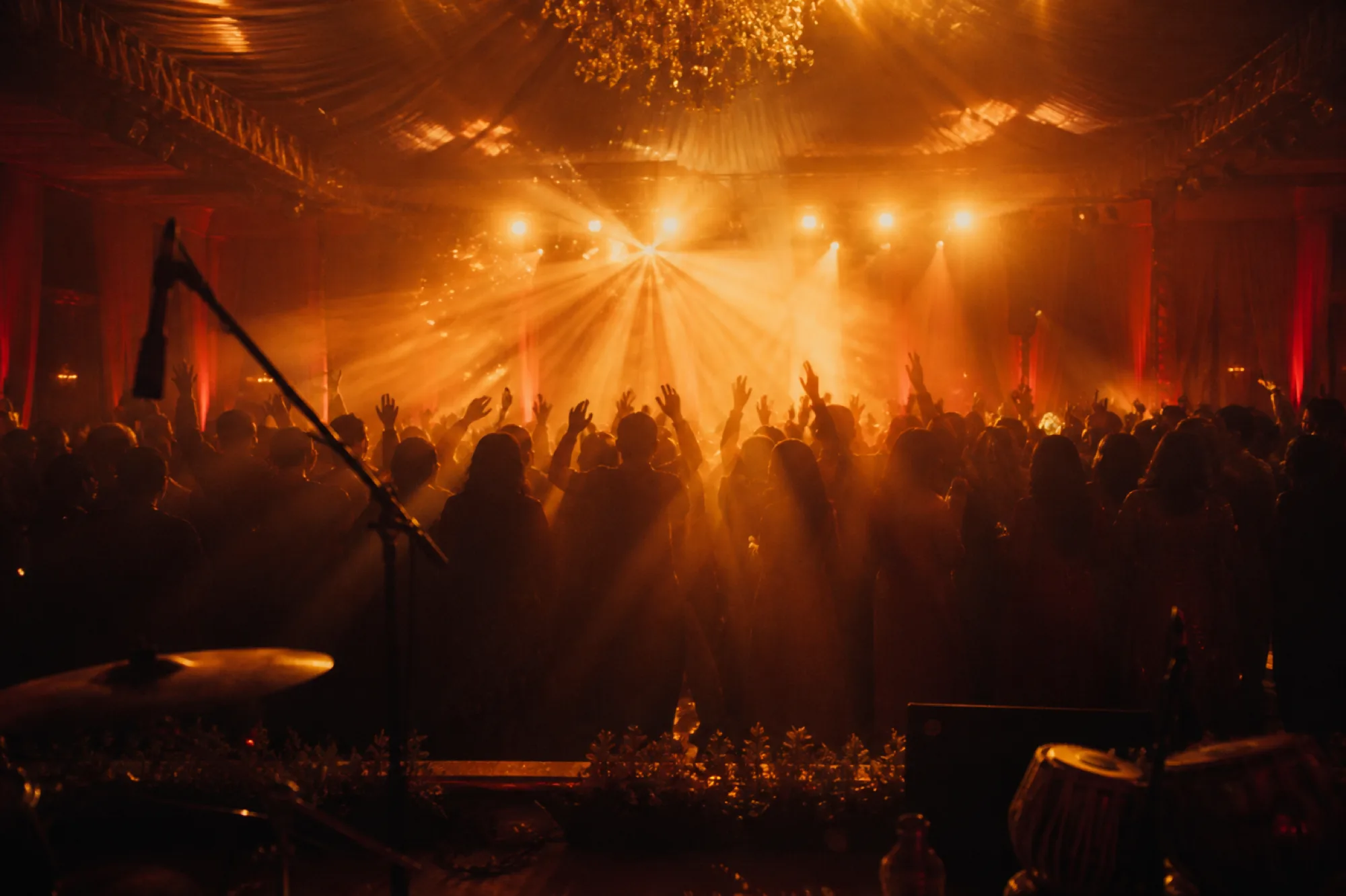 A celebration crowd illuminated by warm stage lights