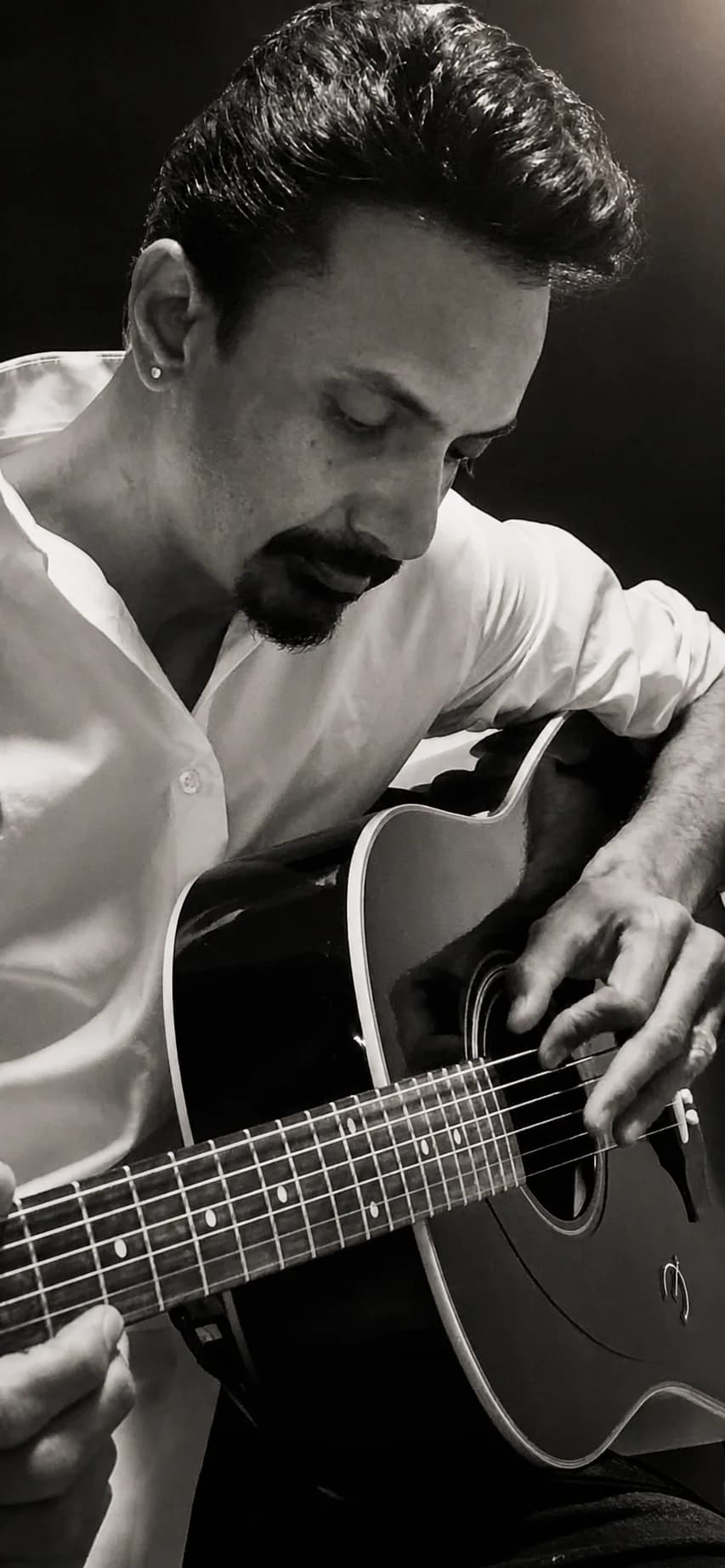 Prakash Parmar playing acoustic guitar