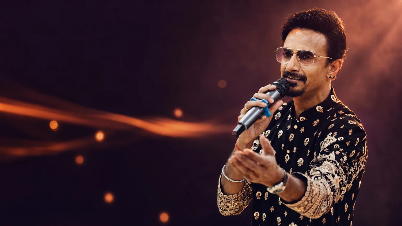 Prakash Parmar singing live into a microphone